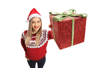 Poster - Young woman wearing a christmas showing a present