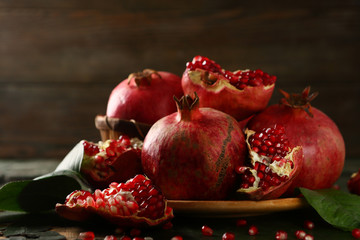 Wall Mural - Red pomegranates closeup on dark