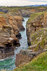 Wall Mural - View of Cathedrals beach natural rock formations  in Ribadeo, Spain, with high tide.