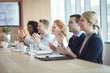 © WavebreakMediaMicro - Happy business people clapping at conference table during