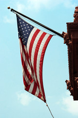 Flag of United States of America and blue cloudy sky