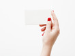 © looking2thesky - Flat lay, top view. Beauty and fashion concept. Beautiful female hands with red manicure. Minimal style. Minimalist photography. Pale composition with girl's hand holding card on white background