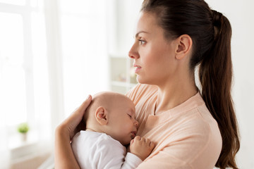 close up of mother holding sleeping baby