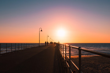 Wall Mural - silhouette at sunset along the glenelg jetty, south australia