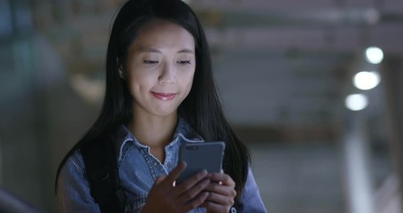 Wall Mural - Young woman use of mobile phone at night