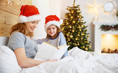 Sticker - family mother reads book to child in bed on Christmas morning