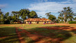 KOLONYI, UGANDA – NOVEMBER 09, 2017: Many students with purple uniform waiting to enter the primary school in Kolonyi near Mbale in Uganda on a beautiful morning in November