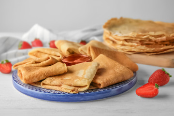 Canvas Print - Plate with delicious thin pancakes on table