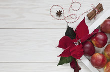 Red Apples, Poinsettia And Christmas Spices. Christmas Concept, Top View, White Wooden Background, Close-up