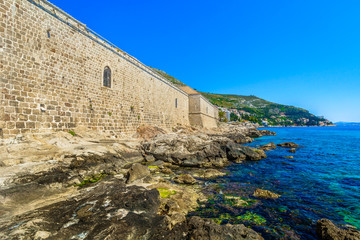 Wall Mural - Lazareti building Dubrovnik coastline. / Coastal view at historical site in Dubrovnik, famous quarantine for plaque disease in Europe, Croatia.