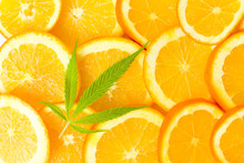 Orange Fruit Slices And Marijuana Leaf