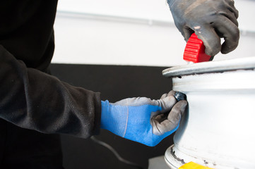 Wall Mural - worker changing the air valve of a tire