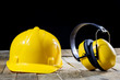 © Piotr - Protective clothing, helmet, gloves and glasses. Hearing protectors. Safety accessories on a wooden table.