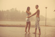 © Miramiska - Loving couple in the rain barefoot. A man and a woman in love.