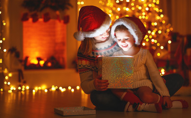 Wall Mural - merry christmas! family mother and child with magic gift at home.