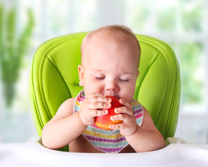 Wall Mural - Baby trying first food.Child with apple.