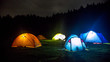 Lighting camp tents with forest in background
