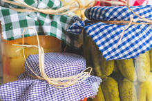 Close Up Of Glass Jars With Pickled Vegetables And Colorful Checkered Fabric Tops, Homemade And Organic Food Concept, Vintage Toned