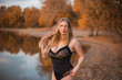 © Михаил Решетников - Young, sexy, chubby Girl in black lace body with very large Breasts lying in the yellow grass in the forest. Autumn, overcast.