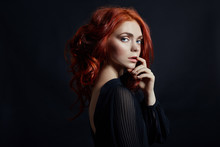 Beautiful Woman With Red Hair On A Black Background. Portrait Of A Successful Woman, Pure Skin, Natural Makeup, Skin Care Face. Contrast Portrait Of A Adult Girl