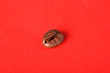 Texture of grains of caffeine.Place for text.Roasted coffee beans.Advertising for coffee.Coffee beans on a red background.