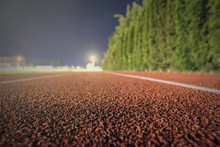 Running Track Close Up. Night Time Shallow Depth Of Field. Sport Background.