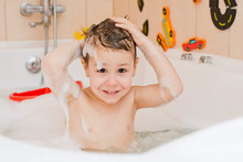 A Child Taking A Bath With Foam