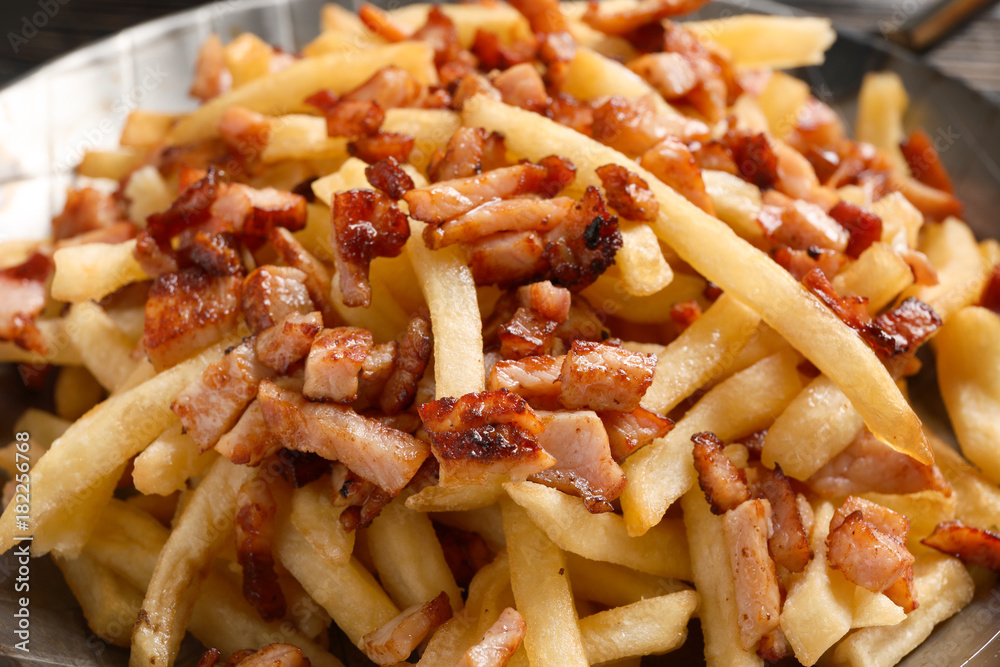 Dish with french fries and bacon, closeup