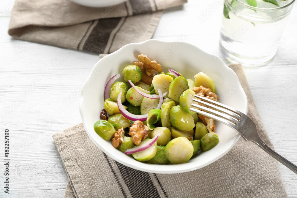 Bowl with brussel sprout salad on table