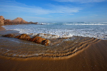 Sticker - Scenic sandy beach with waves and blue sky on a sunny day, South Africa.