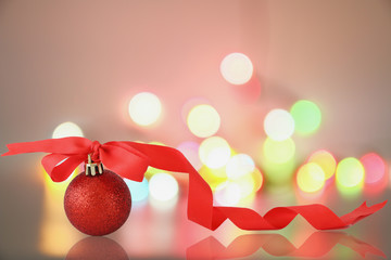 Christmas ornament with red ribbon on lights bokeh background in  new year festive