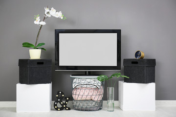 Sticker - Modern TV on stand against grey wall background