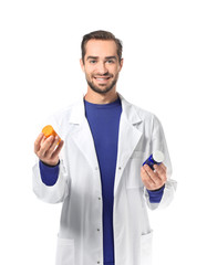 Poster - Young pharmacist with pills on white background