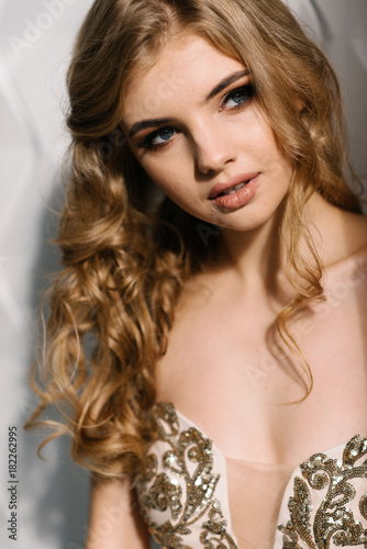 Young Girl With Wavy Hair And Fashion Make Up In Beautiful Dress