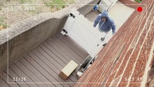 A Clean High Angle Video Feed With Graphic Overlays Showing A Thief Stealing A Package From The Side Of A House In Broad Daylight When No One Is Home.	 	