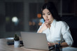 © Vadym Huzhva - Girl is working late in the dark office with a laptop. Young beautiful businesswoman girl in office.
