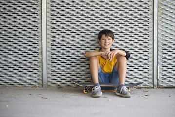 Casual dressed young smiling teen skater outdoors portrait