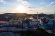 © nikwaller - Aerial view Oil refinery with a background of mountains and sky at sunset. Aerial photography. Kohtla-Järve city, Estonia, Ida-Virumaa.