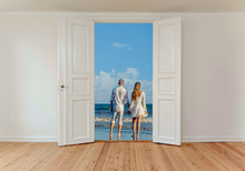 A Married Couple On The Beach Seen Through An Open White Door