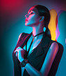 © Subbotina Anna - Portrait of sexy young woman in black clothes,  fashion accessories, bright makeup in neon light