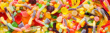 Panorama Close Up A Background From Colorful Sweets Of Sugar Candies And Marmalade.