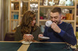 © gihar - cheerful couple at the restaurant drinking tea and having fun