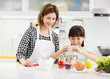 © Tom Wang - Happy mother and child in kitchen preparing cookies.