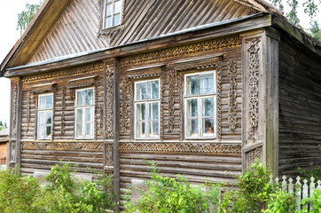 Wall Mural - Traditional old Russian wooden house with carved wooden trim in Novgorod region, Russia