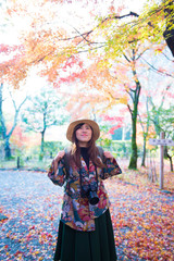 Wall Mural - Asian woman is enjoy travel in Japan during autumn.