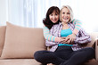 © missty - Two smiling middle aged women, talking at home