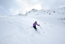 Female Back-country Skier Downhill Skiing From Piz Laschadurella, Sesvenna Alps, Engadin, Graubuenden, Switzerland