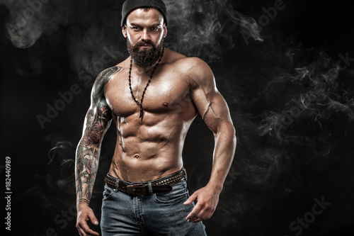 Fotomural Handsome fit man posing wearing in jeans with tattoo