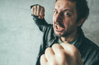 Aggressive man punching with fist, victim's pov