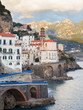 View of a picturesque village clinging to the side of the Amalfi coast with colorful building and ocean in the foreground